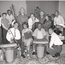 Dave Brubeck, Louis Armstrong, Carmen McRae, and others posing at St. Francis Hotel during rehearsal for Monterey Jazz Festival (San Francisco, California)
