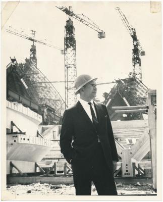 Dave Brubeck in hardhat in front of unfinished Sydney Opera House (Sydney, Australia)