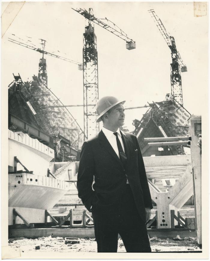 Dave Brubeck in hardhat in front of unfinished Sydney Opera House (Sydney, Australia)