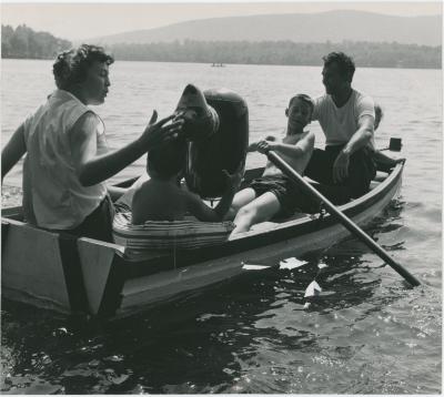 Dave Brubeck, Iola Brubeck, Dan Brubeck, and Michael Brubeck in rowboat with inflatable beach toy on a lake in the Berkshires