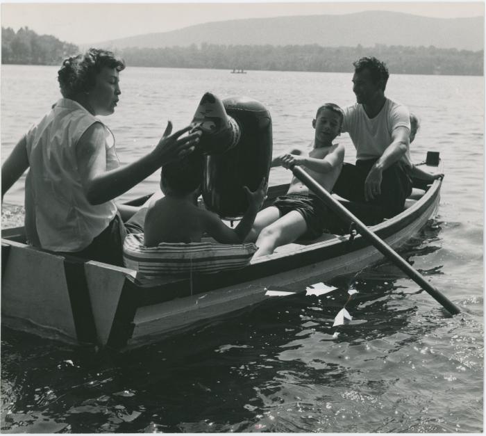 Dave Brubeck, Iola Brubeck, Dan Brubeck, and Michael Brubeck in rowboat with inflatable beach toy on a lake in the Berkshires