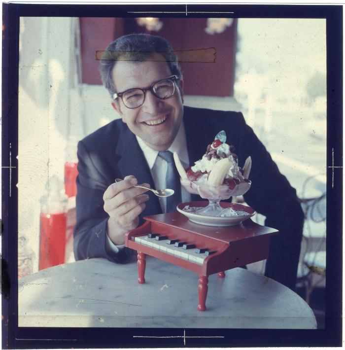 Dave Brubeck eating ice cream on piano