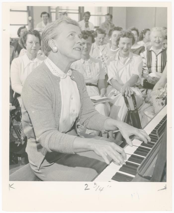 Mrs. Frances Kerr of Berkeley playing piano while class watches during a "Dave teaches teachers" session for Alameda County school teachers (California)