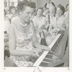Mrs. Evelyn Congeleton of Oakland playing piano while class watches during a "Dave teaches teachers" session for Alameda County school teachers (California)
