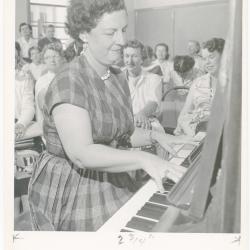 Mrs. Frances Kamps of El Cerrito playing piano while class watches during a "Dave teaches teachers" session for Alameda County school teachers (California)