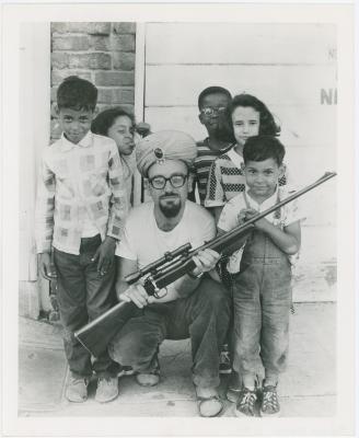 Max Weiss of Fantasy Records with rifle and children