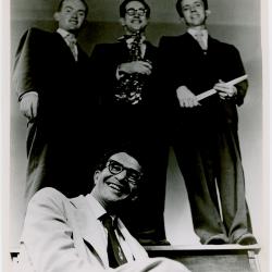Dave Brubeck seated, Paul Desmond, Lloyd Davis, Ron Crotty all standing on upright piano