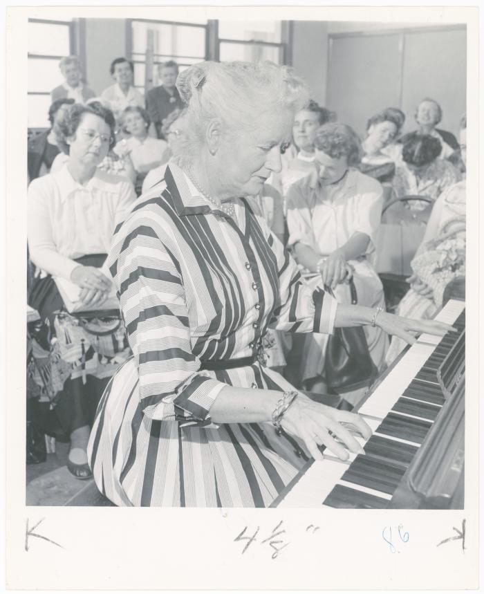 Mrs. Helen Devereaux of Albany playing piano while class watches during a "Dave teaches teachers" session for Alameda County school teachers (California)
