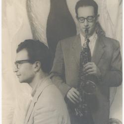 Dave Brubeck, Paul Desmond with saxophone against stylized flames background (New York City, New York)