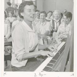 Mrs. Geraldine Hutt of Albany playing piano while class watches during a "Dave teaches teachers" session for Alameda County school teachers (California)