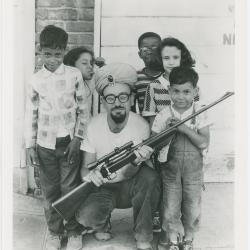 Max Weiss of Fantasy Records with rifle and children
