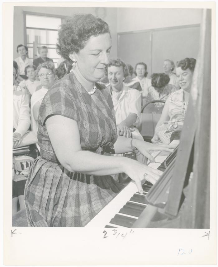 Mrs. Frances Kamps of El Cerrito playing piano while class watches during a "Dave teaches teachers" session for Alameda County school teachers (California)