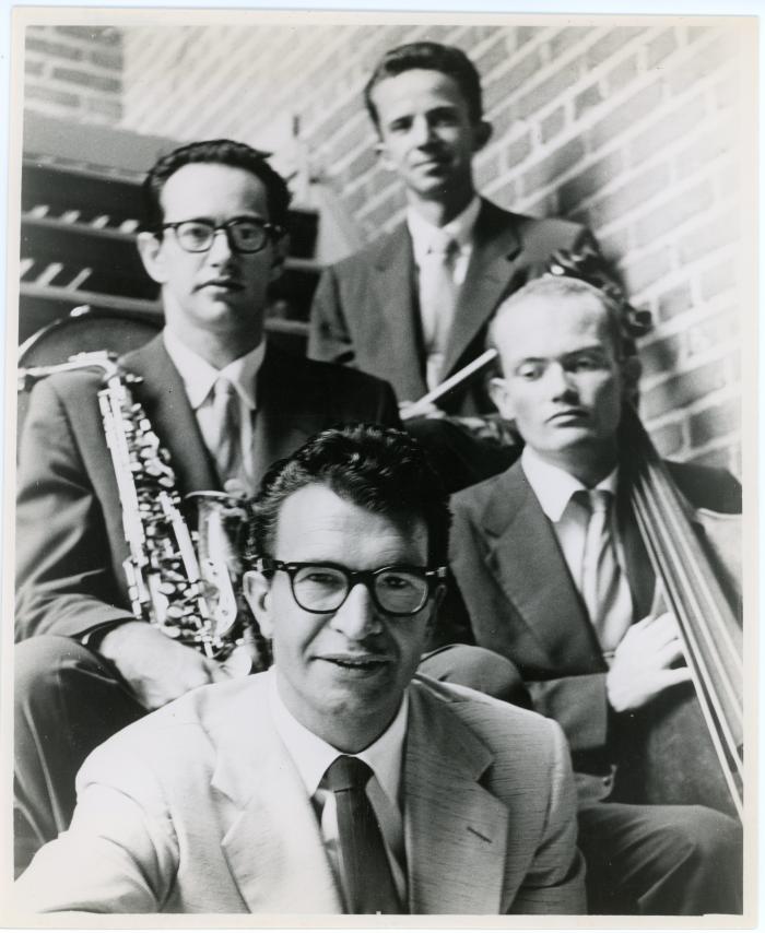 Dave Brubeck, Paul Desmond, Lloyd Davis, Ron Crotty against brick wall