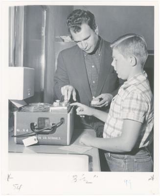 Dave Brubeck and Dickie Roberts preparing tape recorder during a "Dave teaches teachers" session for Alameda County school teachers (California)