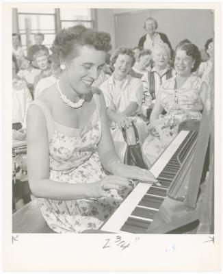 Mrs. Evelyn Congeleton of Oakland playing piano while class watches during a "Dave teaches teachers" session for Alameda County school teachers (California)