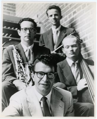 Dave Brubeck, Paul Desmond, Lloyd Davis, Ron Crotty against brick wall