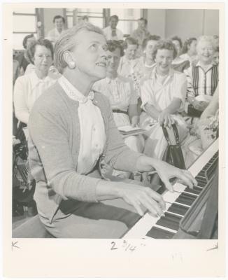 Mrs. Frances Kerr of Berkeley playing piano while class watches during a "Dave teaches teachers" session for Alameda County school teachers (California)