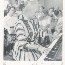 Mrs. Helen Devereaux of Albany playing piano while class watches during a "Dave teaches teachers" session for Alameda County school teachers (California)