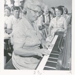 Mrs. Constance Blitz of Albany playing piano while class watches during a "Dave teaches teachers" session for Alameda County school teachers (California)