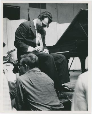 Dave Brubeck signing autographs from the stage, audience in foreground (Gainesville, Florida [?])