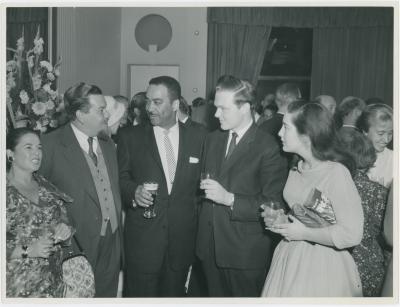 Buck Clayton, two unidentified women and men attending a reception honoring him, Dave Brubeck and Jimmy Rushing (London, United Kingdom)