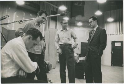 Norman Bates (foreground), Dave Brubeck, Joe Morello, and Paul Desmond listening to playback #4 (New York City, New York [?])