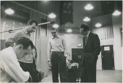 Norman Bates (foreground), Dave Brubeck, Joe Morello, and Paul Desmond listening to playback #2 (New York City, New York [?])