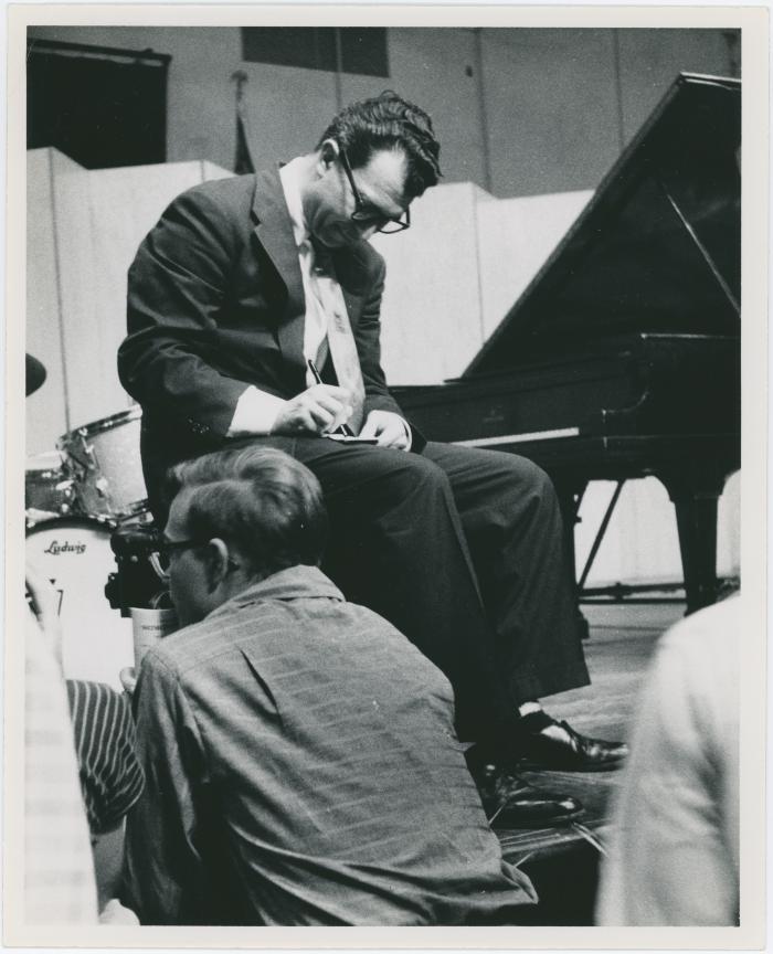Dave Brubeck signing autographs from the stage, audience in foreground (Gainesville, Florida [?])