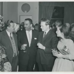 Buck Clayton, two unidentified women and men attending a reception honoring him, Dave Brubeck and Jimmy Rushing (London, United Kingdom)