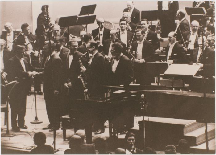 Howard Brubeck shaking hands with Leonard Bernstein, Classic Dave Brubeck Quartet, members New York Philharmonic Orchestra, following a performance of Howard Brubeck's "Dialogues…" (New York City, New York)