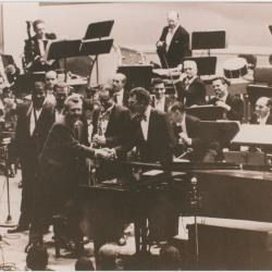 Howard Brubeck shaking hands with Dave Brubeck, (L-R) Eugene Wright, Joe Morello, Paul Desmond, Leonard Bernstein (applauding), members New York Philharmonic Orchestra, following a performance of Howard Brubeck's "Dialogues…" (New York City, New York)