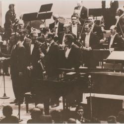 Howard Brubeck shaking hands with Leonard Bernstein, Classic Dave Brubeck Quartet, members New York Philharmonic Orchestra, following a performance of Howard Brubeck's "Dialogues…" (New York City, New York)