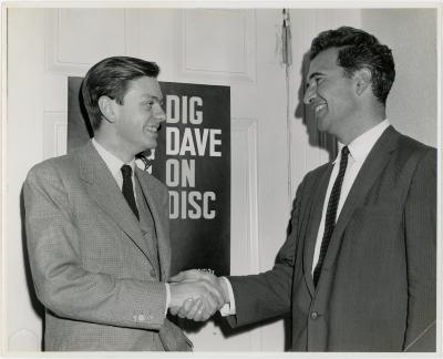 Dave Brubeck shaking hands with classical pianist, Phillippe Entremont in front of the "Dig Dave on Disc" sign (Adelaide, Australia)
