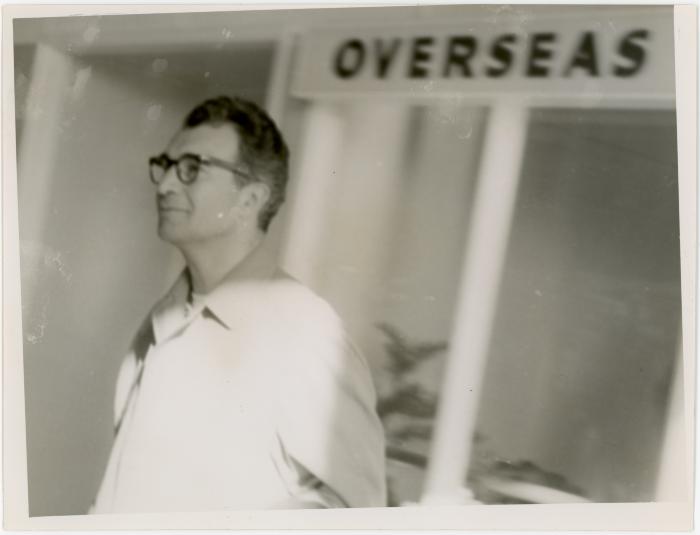 Dave Brubeck at airport with "overseas" sign (Wellington, New Zealand)