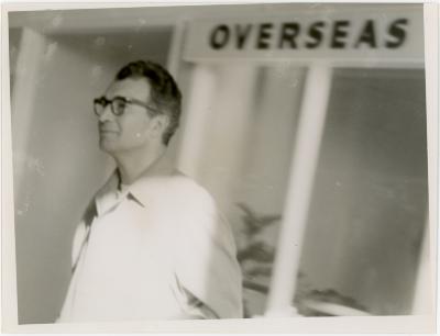 Dave Brubeck at airport with "overseas" sign (Wellington, New Zealand)