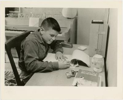 Darius Brubeck studying with Young People's Book of Science at Irving Townsend house (Wilton, Connecticut)